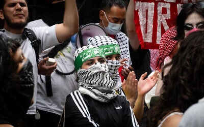 Masked protesters wearing Hamas headbands protest against Baruch College's Hillel student group, in New York City, June 5, 2024. (Luke Tress/JTA)
