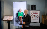 Illustrative: Holocaust survivor Toby Levy next to an interactive artificial intelligence display of herself, at the Museum of Jewish Heritage in New York City, January 27, 2025. (Luke Tress/Times of Israel)