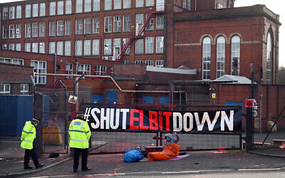 Activists from Palestine Action group protest at the gates of a factory owned by Ferranti, a British subsidiary of Elbit Systems, in England on February 1, 2021. (Paul Ellis/AFP)