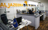 File: An employee of the Qatar based news network and TV channel Al-Jazeera is seen at the channel's Jerusalem office on July 31, 2017. (Ahmad Gharabli / AFP)
