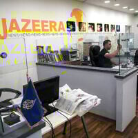 File: An employee of the Qatar based news network and TV channel Al-Jazeera is seen at the channel's Jerusalem office on July 31, 2017. (Ahmad Gharabli / AFP)