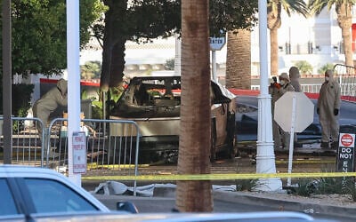 Investigators photograph a Tesla Cybertruck that exploded outside the lobby of President-elect Donald Trump's hotel on January 1, 2025, in Las Vegas. (WADE VANDERVORT / AFP)
