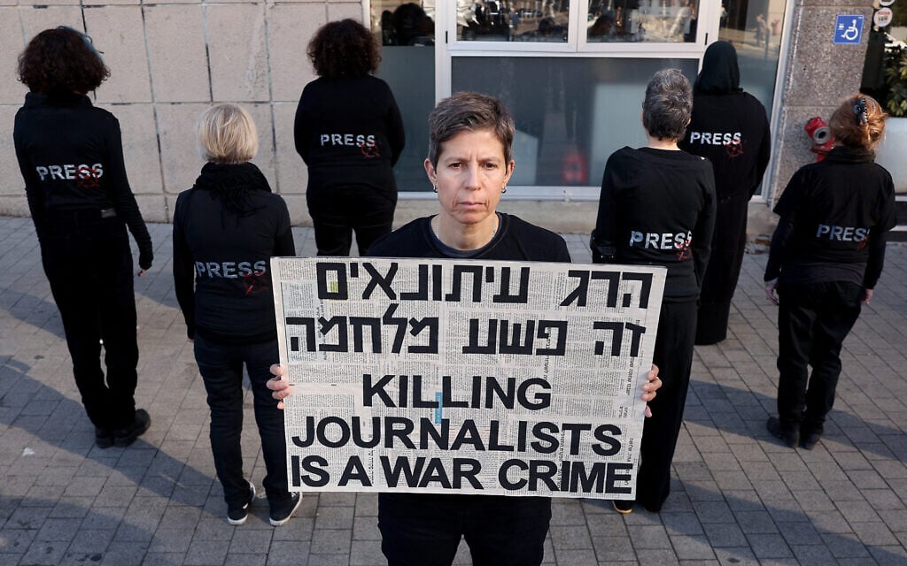 Activists hold a silent demonstrations to protest the killing of journalists and calling for an end to the war between Israel and Hamas terrorists in the Gaza Strip, in Tel Aviv, on January 3, 2025. (Jack Guez/AFP)