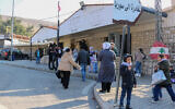 People wait at the entrance of the Al-Masnaa eastern Lebanese border crossing with Syria on January 3, 2025, after Syria imposed new restrictions on the entry of Lebanese citizens. (Hassan JARRAH / AFP)