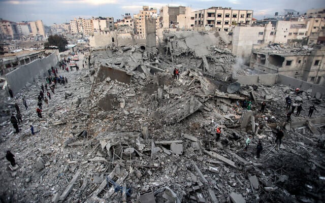 People inspect the rubble of a collapsed building that was hit by Israeli strikes in the Saraya area in al-Rimal in central Gaza City on January 4, 2025  (Photo by Omar AL-QATTAA / AFP)