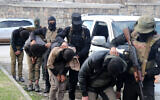 This handout picture released by the official Syrian Arab News Agency (SANA) on January 6, 2025, shows fighters affiliated with Syria's new administration taking men into custody in Syria's west-central city of Homs. (SANA / AFP)