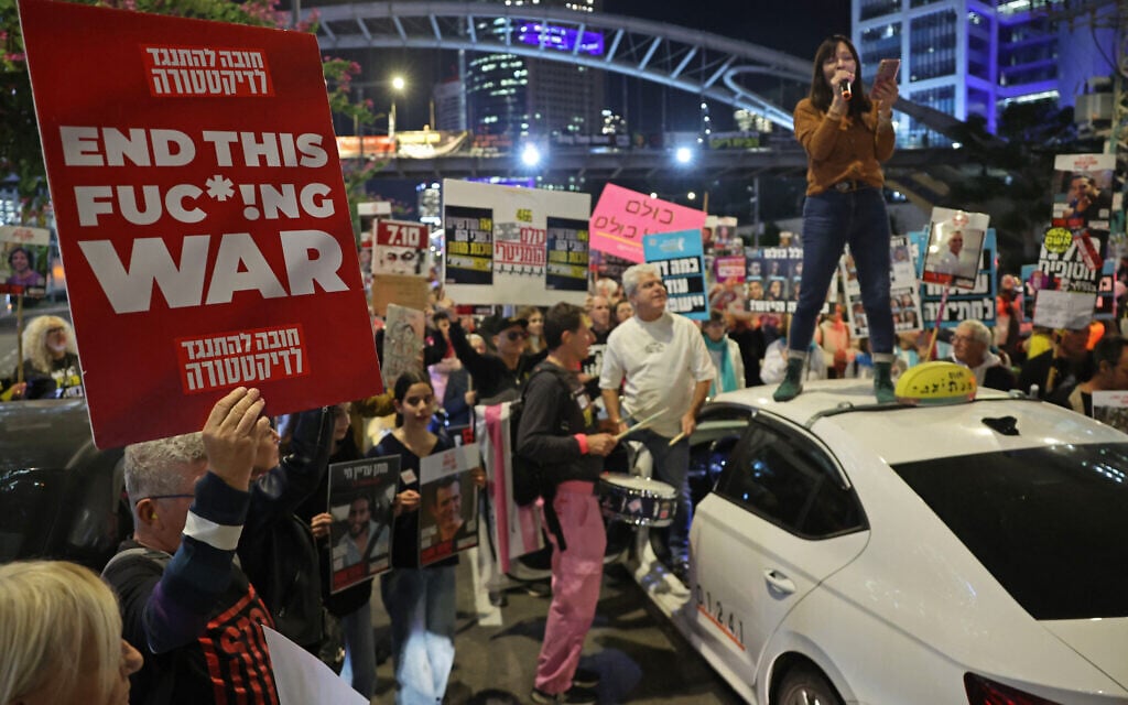 Demonstrators raise placards during a protest calling for action to secure the release of Israelis held hostage in Gaza since October 7, 2023, in front of the Israeli defense ministry in Tel Aviv on January 14, 2025. (Jack GUEZ / AFP)