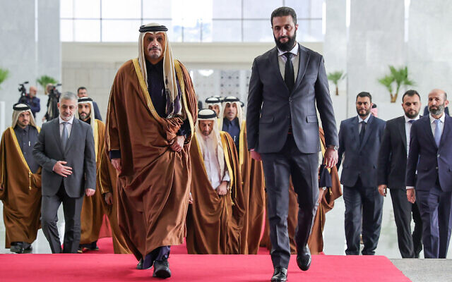 This handout picture released by the Syrian Arab News Agency SANA, shows Syria's new leader Ahmed al-Sharaa (R) welcoming Qatari Prime Minister Sheikh Mohammed bin Abdulrahman bin Jassim al-Thani in Damascus on January 16, 2025. (SANA/AFP)