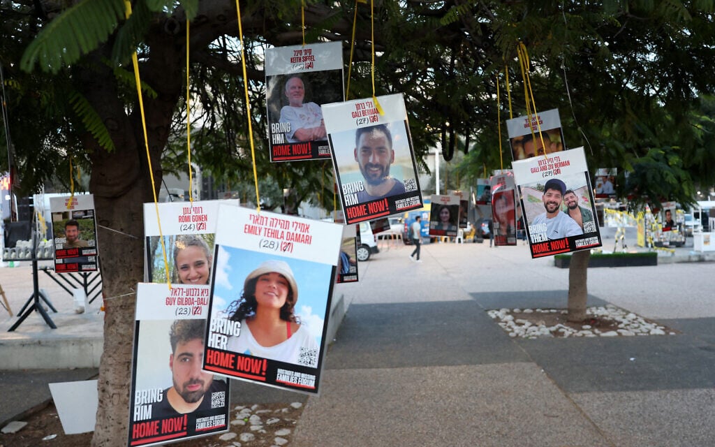 Pictures of Israeli hostages held by Hamas in Gaza since October 7, 2023, hang from trees at the so-called Hostages Square in Tel Aviv, January 16, 2025.. (Jack Guez/AFP)