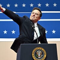 Elon Musk gestures as he speaks during the inaugural parade inside Capitol One Arena in Washington, on January 20, 2025. (Angela Weiss/AFP)