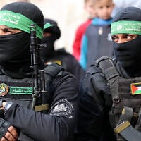 Members of the Izz ad-Din al-Qassam Brigades, the Hamas terror group's military wing, attend the funeral of two fighters in Gaza City on January 24, 2025. (Omar al-Qattaa/AFP)