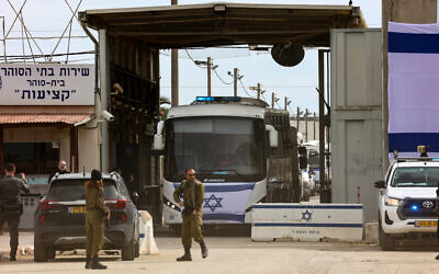 Israeli security forces stand guard as buses transporting Palestinian prisoners being released as part of a hostage-ceasefire deal with Hamas leave the Ketziot prison in the Negev desert on January 25, 2025. (Gil Magen-Cohen/AFP)