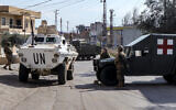 An armored vehicle of the United Nations Interim Force in Lebanon (UNIFIL) approaches a Lebanese army roadblock near a checkpoint in the village of Burj el-Meluk in Nabatiyeh in southern Lebanon near the border with Israel on January 25, 2025. (Rabih DAHER / AFP)