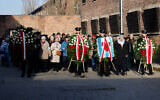Survivors, relatives and representatives of the Memorial and Museum of Auschwitz-Birkenau lay wreaths and light candles at the so-called Death Wall next to Block 11 of the former Auschwitz I main camp in Oswiecim, Poland on January 27, 2025, during commemorations on the 80th anniversary of the liberation of the German Nazi concentration and extermination camp Auschwitz-Birkenau by the Red Army. (Wojtek RADWANSKI / AFP)