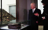 Britain's King Charles III looks at discarded personal belongings next to a showcase with shoes of victims during a tour at the Memorial and Museum Auschwitz-Birkenau, at the site of the former German Nazi concentration and extermination camp, in Oswiecim, Poland, on January  27, 2025, following commemorations on the 80th anniversary of the camp's liberation by the Red Army. (Aaron Chown / POOL / AFP)