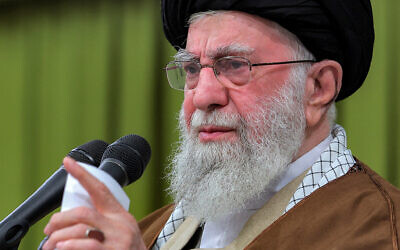 Iran's Supreme Leader Ayatollah Ali Khamenei shows him (L) addressing attendees while accompanied on stage by President Masoud Pezeshkian during a meeting with officials in Tehran on January 28, 2025. (KHAMENEI.IR / AFP)