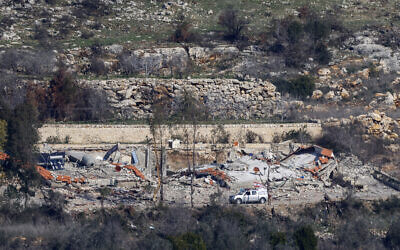 This picture, taken from a position in northern Israel near the border with Lebanon, shows civilian Lebanese cars driving near destroyed buildings in the southern Lebanese village of Aita al-Shaab on January 29, 2025. (Jalaa Marey / AFP)