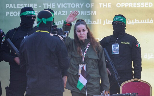 Hostage soldier Agam Berger is seen on a stage in northern Gaza's Jabalia, surrounded by Hamas gunmen, before she is handed over to the Red Cross on January 30, 2025 (Omar AL-QATTAA / AFP) Hostage soldier Agam Berger is seen on a stage in northern Gaza's Jabalia, surrounded by Hamas gunmen, before she is handed over to the Red Cross on January 30, 2025 (Omar AL-QATTAA / AFP)