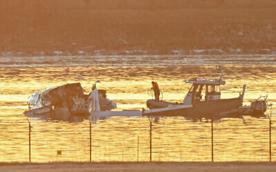 Part of the wreckage is seen as rescue boats search the waters of the Potomac River after a plane on approach to Reagan National Airport crashed into the river near Washington, DC, on January 30, 2025. (Andrew CABALLERO-REYNOLDS / AFP)