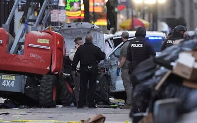 Emergency services attend the scene on Bourbon Street after a vehicle drove into a crowd on New Orleans' Canal and Bourbon Street, Wednesday Jan. 1, 2025. (AP Photo/Gerald Herbert)