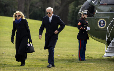 US President Joe Biden and first lady Jill Biden walk across the South Lawn of the White House, January 2, 2025, in Washington, after returning from Camp David. (AP Photo/Mark Schiefelbein)