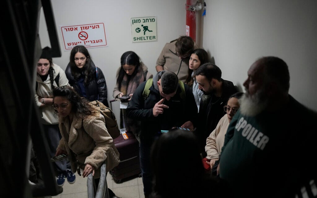 People gather in a shelter after air raid sirens sounded off in Ben Gurion Airport, near Tel Aviv, Israel, January 3, 2025. (AP Photo/Matias Delacroix)
