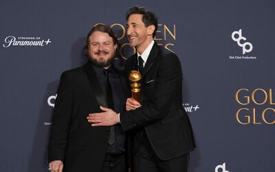 Brady Corbet, winner of the award for best director - motion picture for 'The Brutalist,' left, Adrien Brody, winner of the award for best performance by a male actor in a motion picture - drama for 'The Brutalist,' pose in the press room during the 82nd Golden Globes on January 5, 2025, at the Beverly Hilton in Beverly Hills, California. (AP Photo/Chris Pizzello)