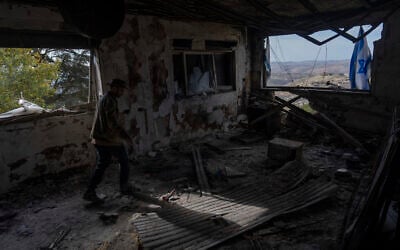 Igor Abramovich surveys heavy damage to a house from the conflict between Hezbollah and Israel in Kibbutz Manara, on the border with Lebanon, northern Israel, January 5, 2025. (AP Photo/Ariel Schalit)