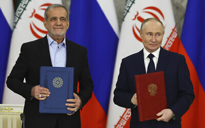 Russian President Vladimir Putin, right, and Iranian President Masoud Pezeshkian attend a signing ceremony at the Kremlin in Moscow, Russia, January 17, 2025. (Evgenia Novozhenina/Pool Photo via AP)