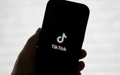 A TikTok logo is shown on a phone in San Francisco, January 17, 2025. (AP Photo/Jeff Chiu)