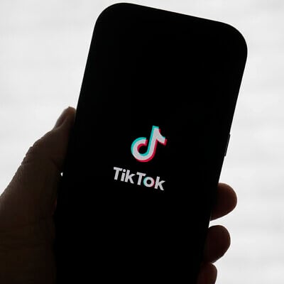 A TikTok logo is shown on a phone in San Francisco, January 17, 2025. (AP Photo/Jeff Chiu)