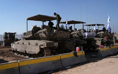 Israeli soldiers work in a staging area on the Israel-Gaza border after returning from the Gaza Strip, Saturday, Jan. 18, 2025, a day ahead of a ceasefire between Israel and Hamas. (AP Photo/Tsafrir Abayov)