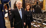 Sen. Mitch McConnell, left, arrives with his wife, former US Secretary of Transportation Elaine Chao, before the Inauguration of US President Donald Trump, in the Rotunda of the US Capitol in Washington, January 20, 2025. (Chip Somodevilla/Pool Photo via AP)