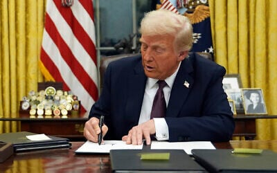 US President Donald Trump signs an executive order in the Oval Office of the White House, January 20, 2025, in Washington. (AP Photo/Evan Vucci)