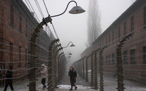 People visit the Memorial and Museum at Auschwitz-Birkenau, a former Nazi German concentration and extermination camp, in Oswiecim, Poland, January 23. 2025. (AP Photo/Oded Balilty)