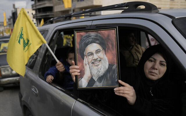 A Lebanese woman holds a portrait of slain Hezbollah chief Hassan Nasrallah, as she sits in a car with her family on their way to Bint Jbeil in south Lebanon, January 26, 2025. (AP Photo/Bilal Hussein) A Lebanese woman holds a portrait of slain Hezbollah chief Hassan Nasrallah, as she sits in a car with her family on their way to Bint Jbeil in south Lebanon, January 26, 2025. (AP Photo/Bilal Hussein)