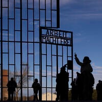 People visit the Nazi Concentration Camp Sachsenhausen on International Holocaust Remembrance Day, in Oranienburg, Germany, January 27, 2025. (AP Photo/Markus Schreiber)