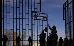 People visit the Nazi Concentration Camp Sachsenhausen on International Holocaust Remembrance Day, in Oranienburg, Germany, January 27, 2025. (AP Photo/Markus Schreiber)