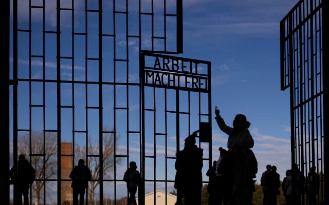 People visit the Nazi Concentration Camp Sachsenhausen on International Holocaust Remembrance Day, in Oranienburg, Germany, January 27, 2025. (AP Photo/Markus Schreiber)