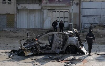 Illustrative: People view wreckage of a vehicle destroyed in an Israeli strike in the refugee camp of Nur Shams, near Tulkarem in the northern Wet Bank, January 27, 2025. (AP Photo/Majdi Mohammed)