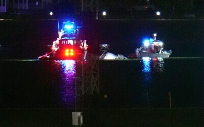 Boats work the scene on the Potomac River near Ronald Reagan Washington National Airport, Jan. 29, 2025, in Arlington, Va. after a deadly midair collision (AP Photo/Julio Cortez)