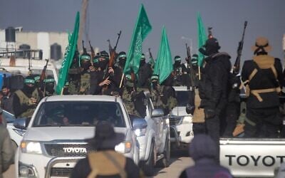 A crowd greets Islamic Jihad and Hamas terror operatives as they arrive for the handover of hostages to the Red Cross in the south Gaza Strip town of Khan Younis, Jan. 30, 2025. (AP Photo/Jehad Alshrafi)