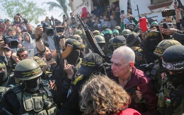 Gadi Mozes is escorted by Hamas and Palestinian Islamic Jihad gunmen as he is handed over to the Red Cross in Khan Younis, southern Gaza, Jan. 30, 2025. (AP/Jehad Alshrafi)