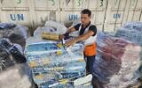 United Nations and Red Crescent workers prepare the aid for distribution to Palestinians at UNRWA warehouse in Deir Al-Balah, Gaza Strip, on Monday, Oct. 23, 2023. (AP Photo/Hassan Eslaiah, File)