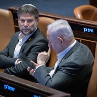 Finance Minister Bezalel Smotrich (left) and Prime Minister Benjamin Netanyahu attend a vote in the Knesset plenum,  Jerusalem, December 31, 2024. (Chaim Goldberg/Flash90)