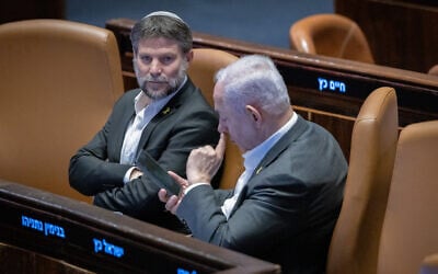 Finance Minister Bezalel Smotrich (left) and Prime Minister Benjamin Netanyahu attend a vote in the Knesset plenum,  Jerusalem, December 31, 2024. (Chaim Goldberg/Flash90)