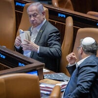 Prime Minister Benjamin Netanyahu (left) with National Security Minister Itamar Ben Gvir (right) in the Knesset on December 31, 2024 (Chaim Goldberg / Flash 90)