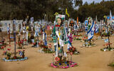 Photos of Israelis murdered at the Nova music festival on October 7, 2023, are posted at the site of the massacre, in southern Israel's Re'im, January 16, 2025. (Chaim Goldberg/Flash90)