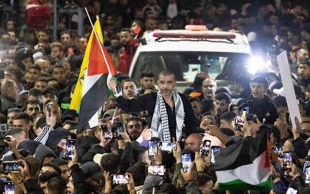 A crowd greets terrorist Zakaria Zubeidi, former head of the Al-Aqsa Brigades, after his release as part of a hostage-ceasefire deal between Israel and Hamas as he arrives in Ramallah, in the West Bank, January 30, 2025. (Flash90)