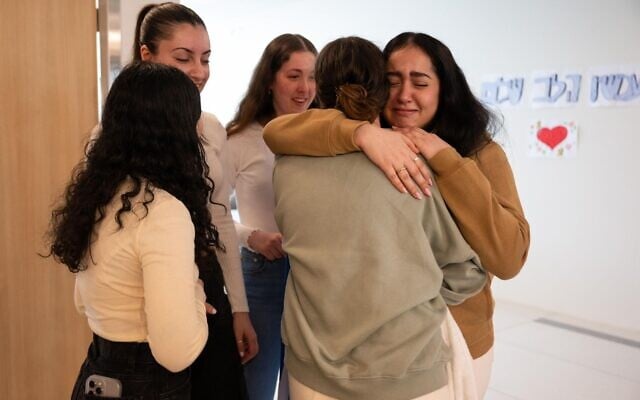 Released hostage soldier Agam Berger meets her four comrades, Karina Ariev, Daniella Gilboa, Naama Levy, and Liri Albag, at Rabin Medical Center, January 30, 2025. (Israel Defense Forces)